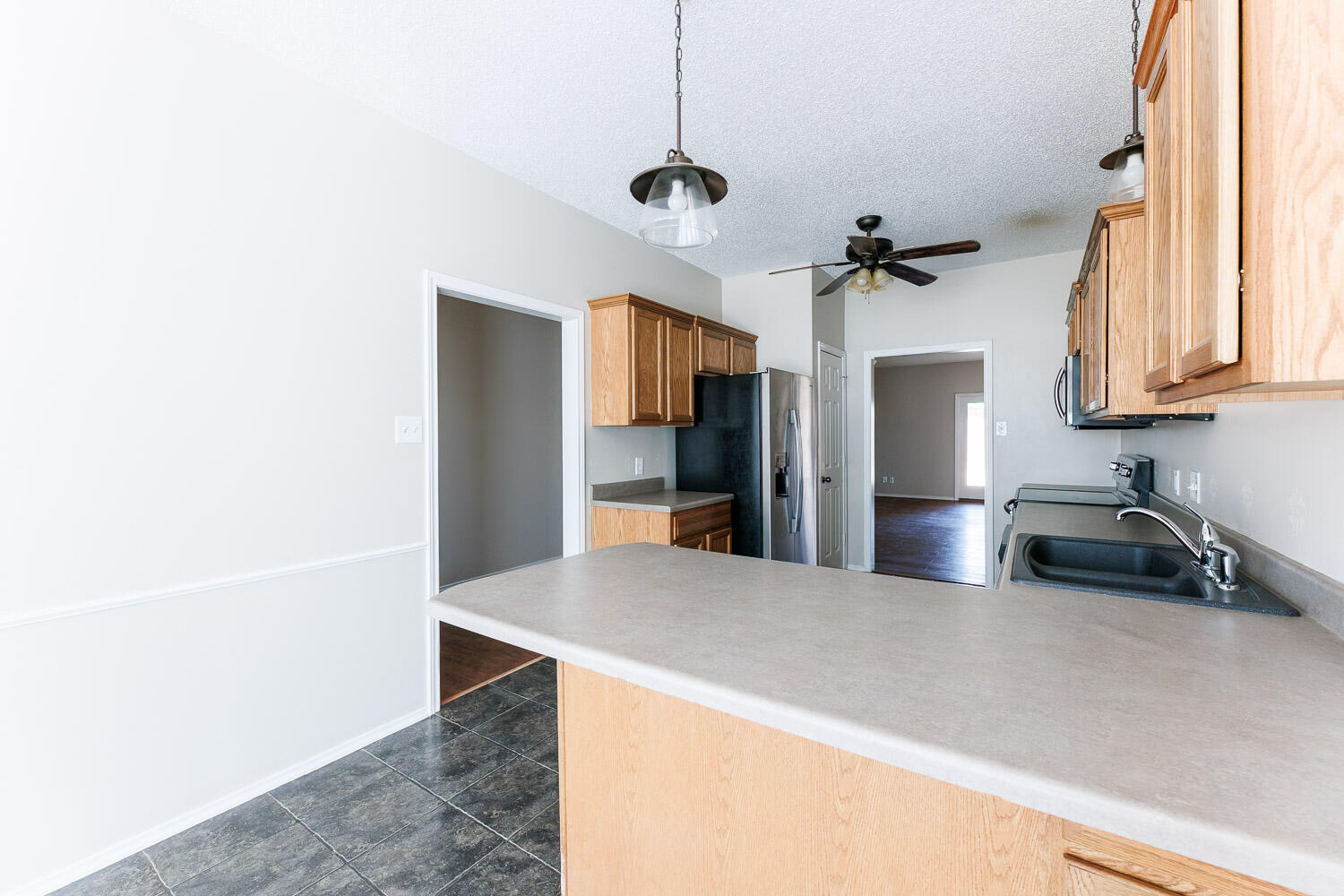6704 87th Street Lubbock, TX 79424 - Photo 15 of 49 a kitchen with stainless steel appliances a refrigerator and a stove top oven