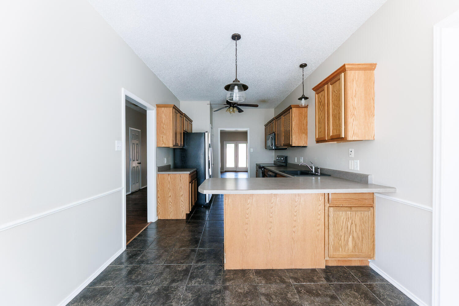 6704 87th Street Lubbock, TX 79424 - Photo 16 of 49 a kitchen with stainless steel appliances granite countertop a refrigerator a stove top oven a sink and dishwasher
