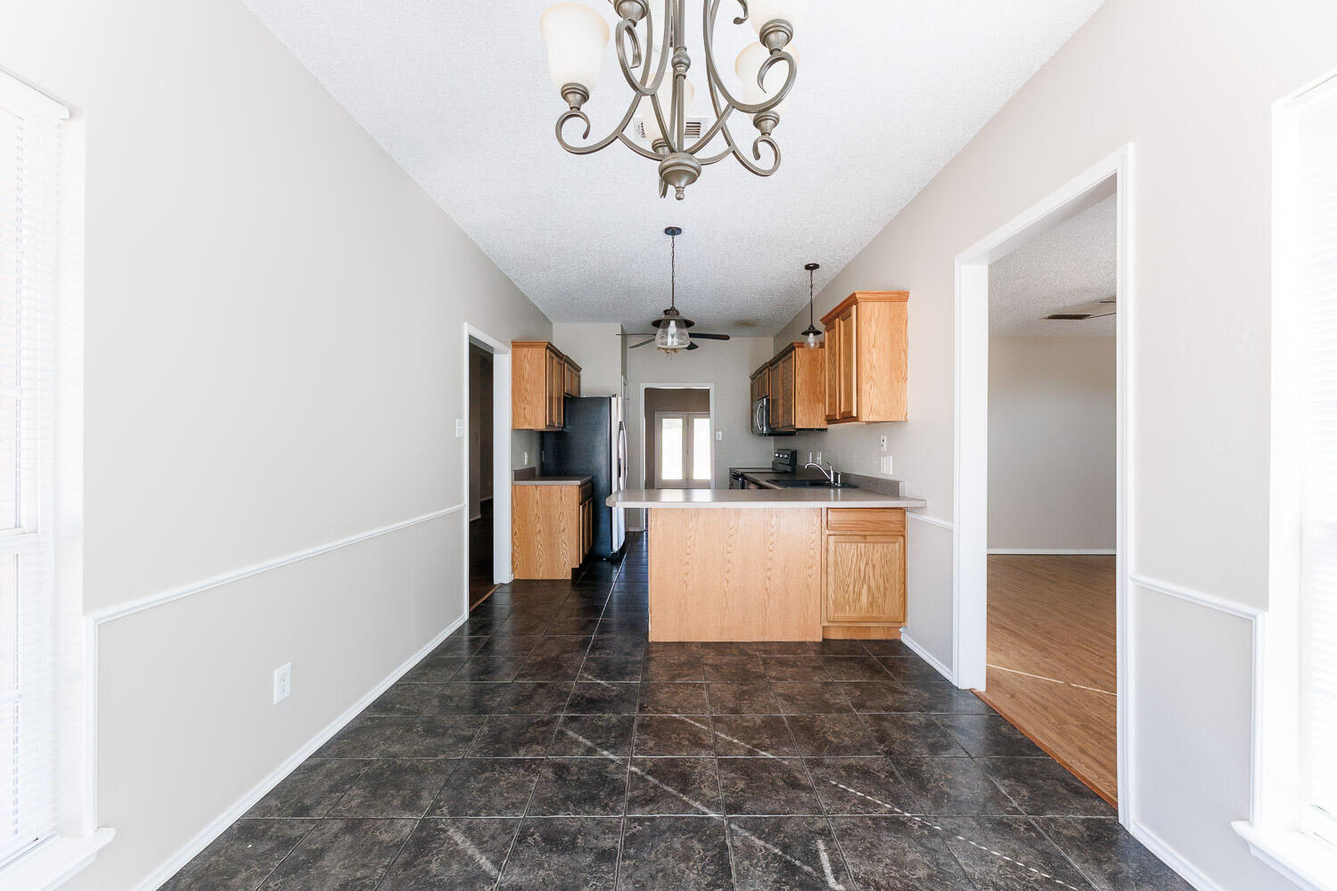 6704 87th Street Lubbock, TX 79424 - Photo 17 of 49 a large kitchen with a refrigerator a stove top oven a sink and dishwasher