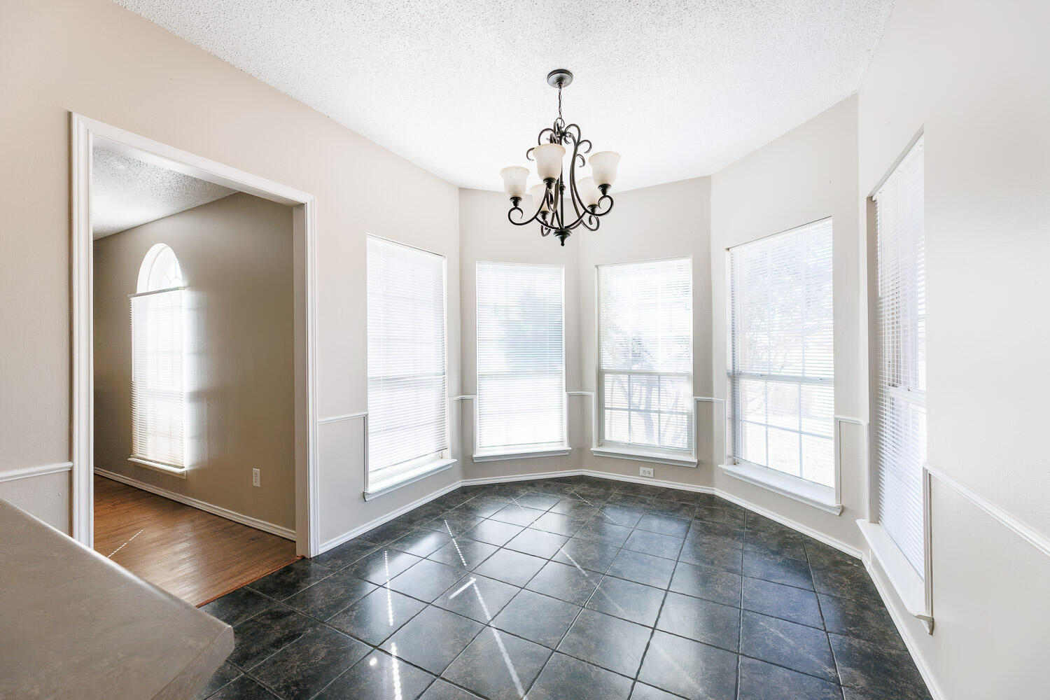 6704 87th Street Lubbock, TX 79424 - Photo 18 of 49 a view of an empty room with window and chandelier fan