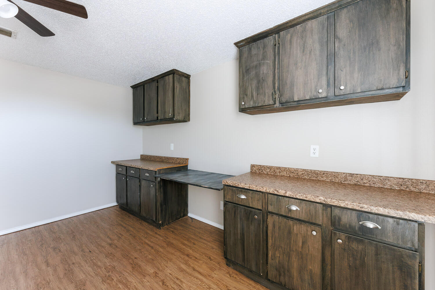 6704 87th Street Lubbock, TX 79424 - Photo 20 of 49 a kitchen with stainless steel appliances granite countertop a sink and wooden cabinets