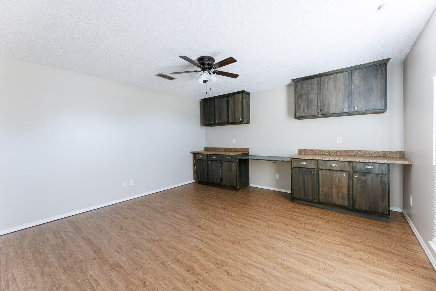 6704 87th Street Lubbock, TX 79424 - Photo 22 of 49 a view of a kitchen with wooden floor and electronic appliances