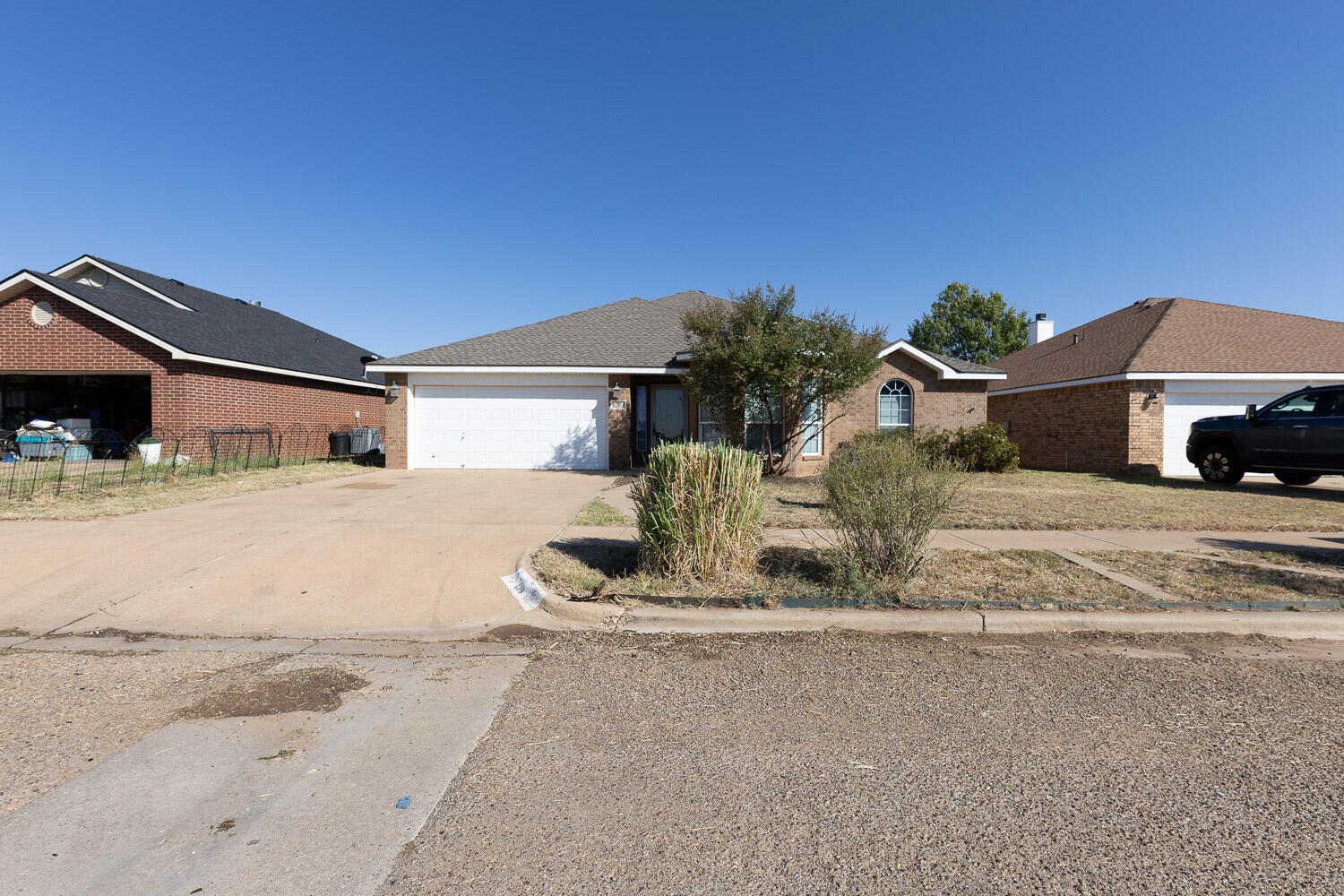 6704 87th Street Lubbock, TX 79424 - Photo 3 of 49 a front view of a house with a yard