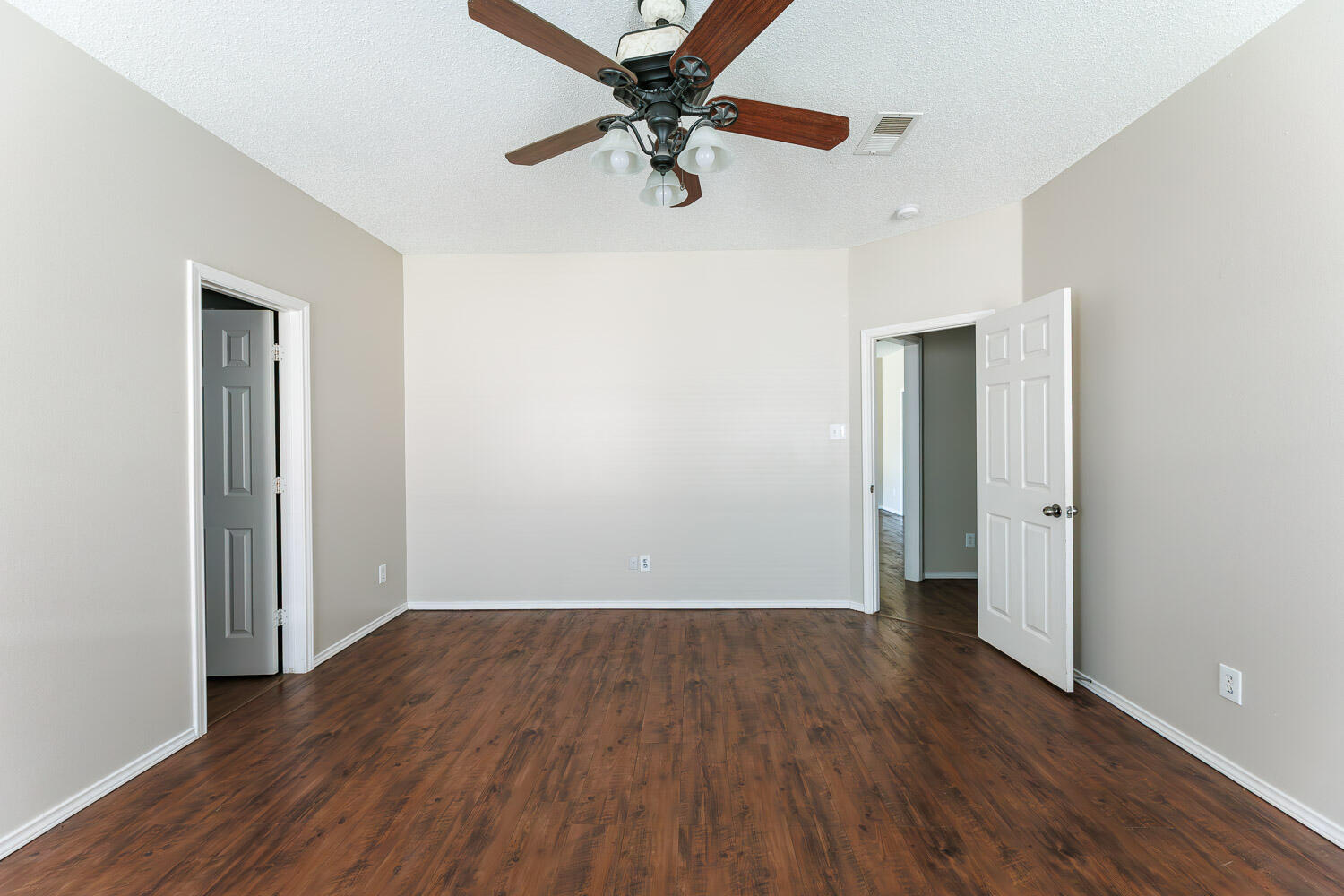 6704 87th Street Lubbock, TX 79424 - Photo 31 of 49 an empty room with wooden floor a ceiling fan and closet