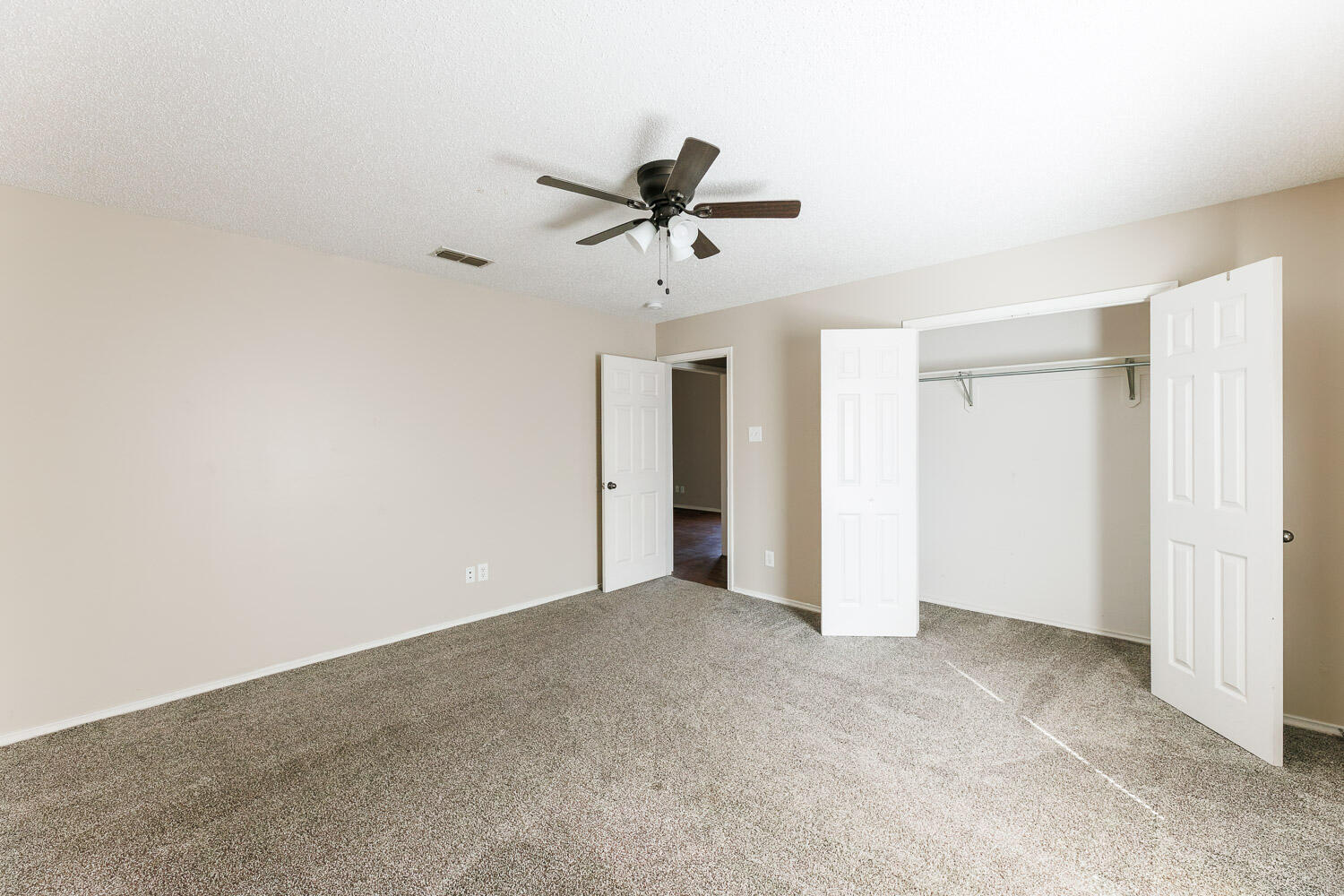 6704 87th Street Lubbock, TX 79424 - Photo 41 of 49 an empty room with a ceiling fan and carpet