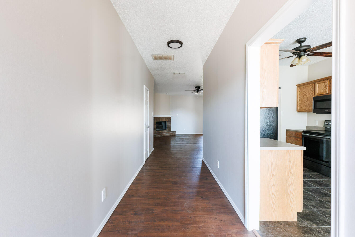 6704 87th Street Lubbock, TX 79424 - Photo 5 of 49 a view of a hallway with wooden floor and staircase