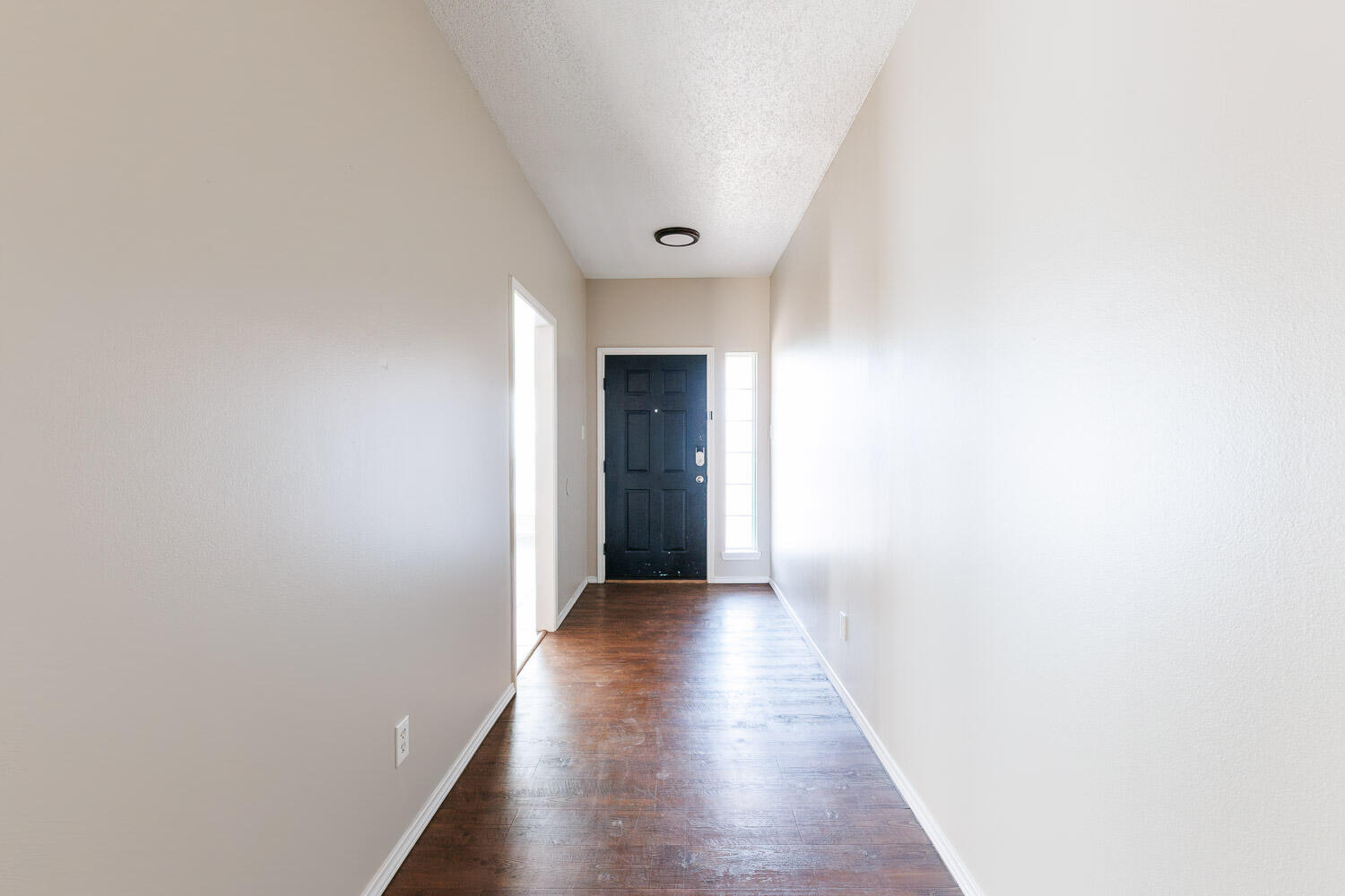 6704 87th Street Lubbock, TX 79424 - Photo 6 of 49 a view of a hallway with wooden floor