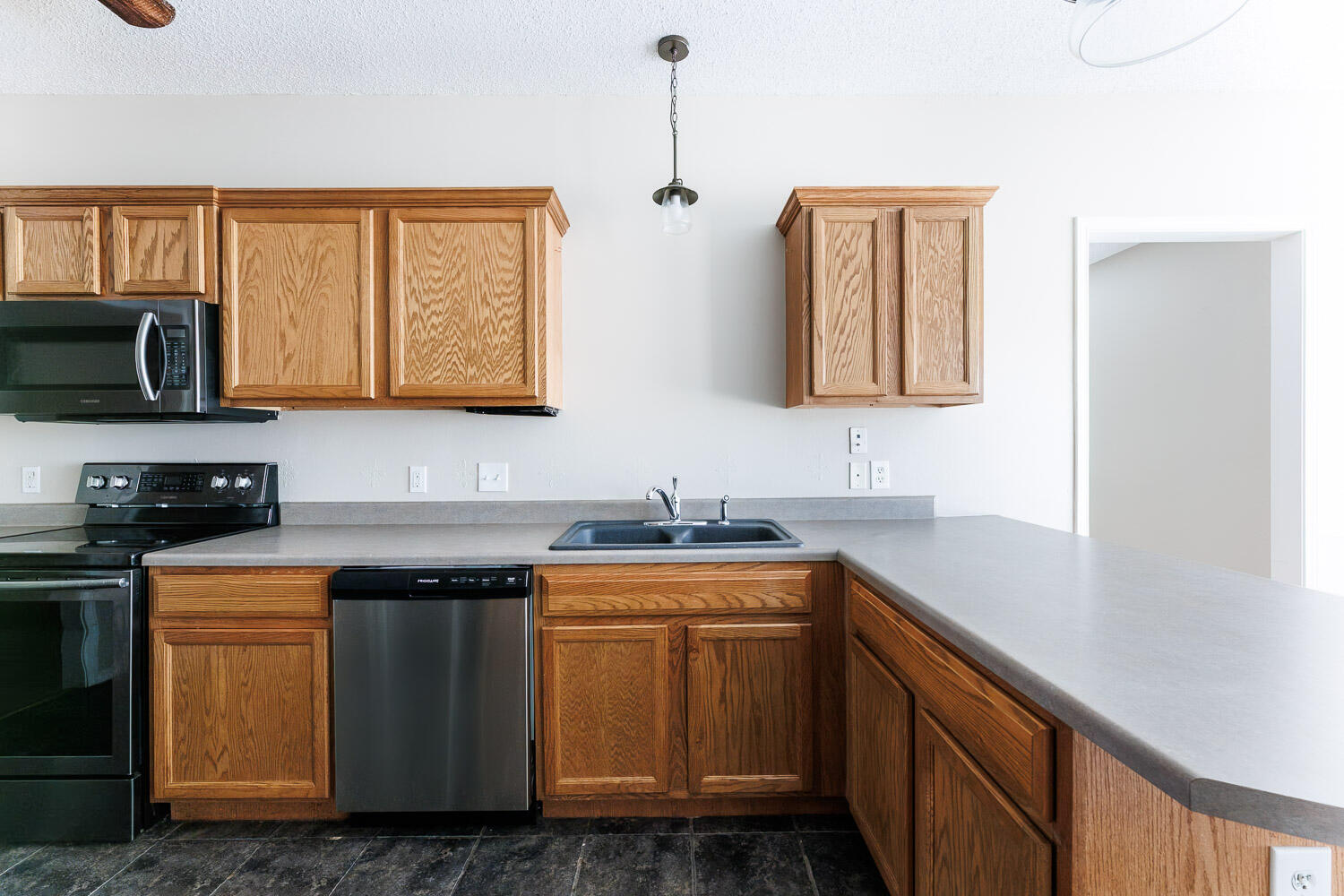 6704 87th Street Lubbock, TX 79424 - Photo 10 of 49 a kitchen with stainless steel appliances granite countertop a sink stove and microwave
