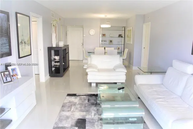 a living room with furniture and a mirror