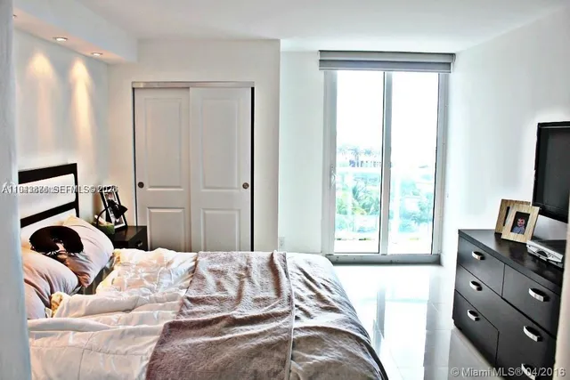 a bedroom with a bed and a television