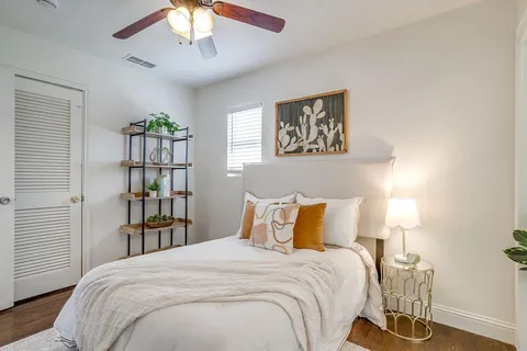 a bedroom with a bed and a book shelf