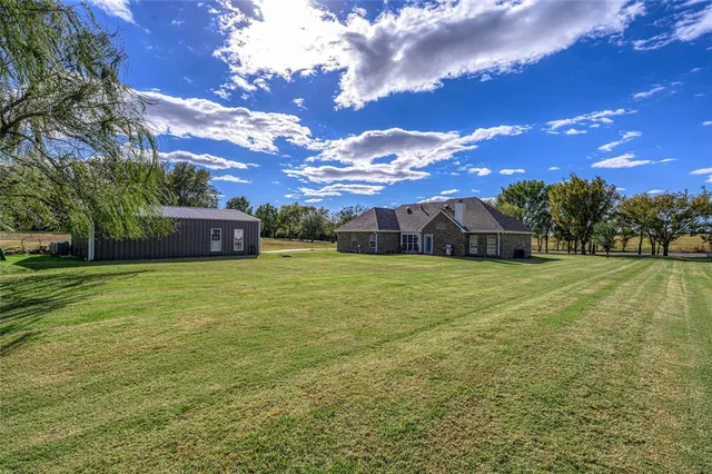 a view of an house with backyard space and garden