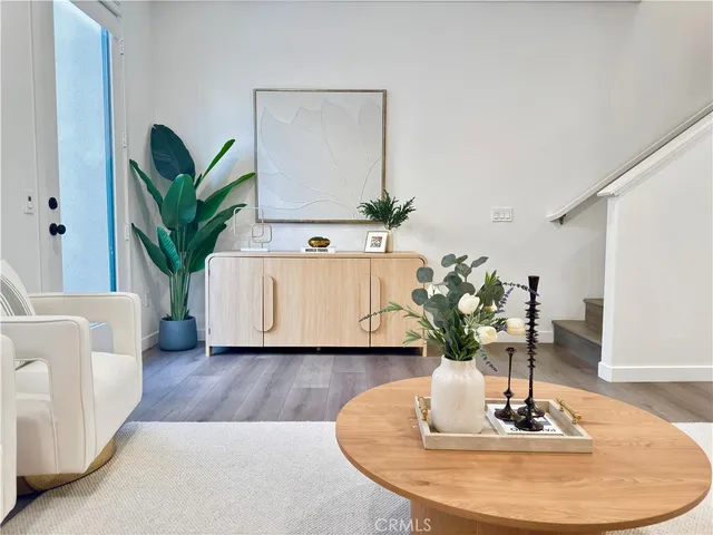 a living room with furniture and a potted plant