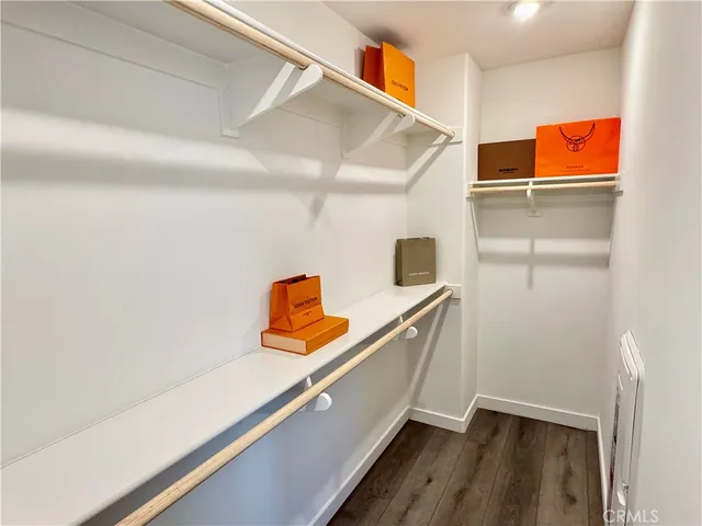 a hallway with sliding door and wooden floor