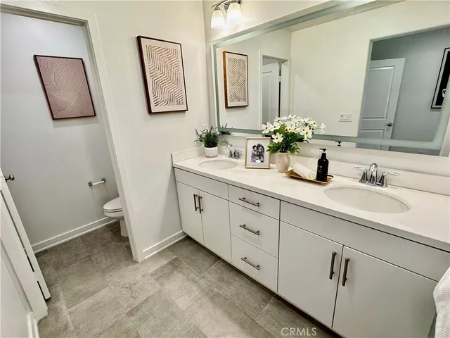 a bathroom with a double vanity sink and mirror