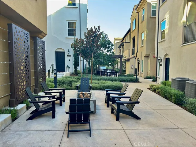 a view of a patio with table and chairs and potted plants