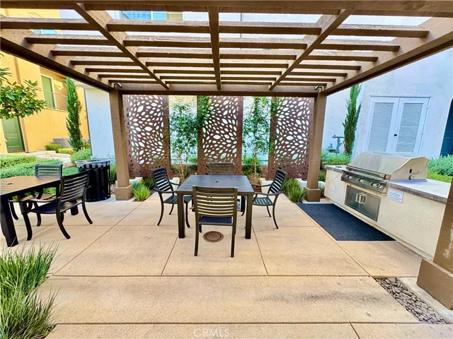 a patio with yard and outdoor seating