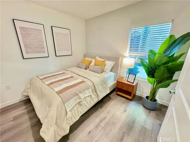 a bedroom with bed window and table