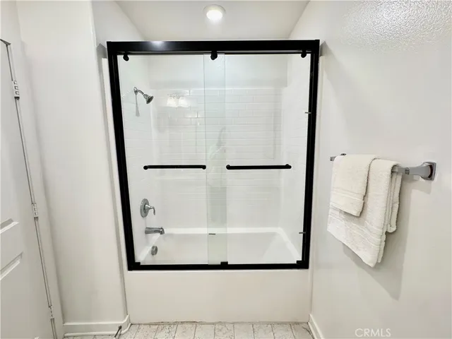 a bathroom with a glass shower door