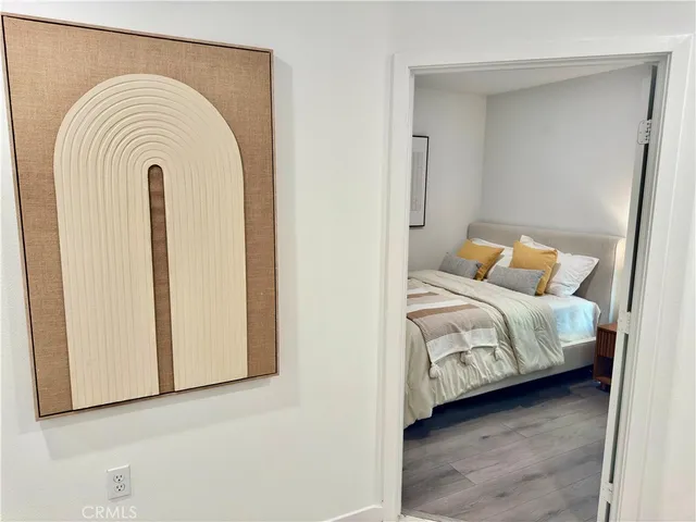 a bedroom with a bed and a mirror