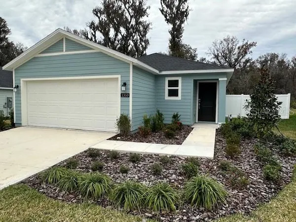 a front view of house with yard and trees