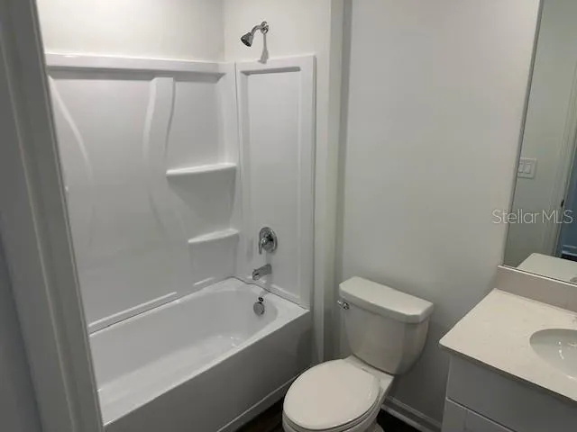 a white toilet sitting next to a bathroom sink