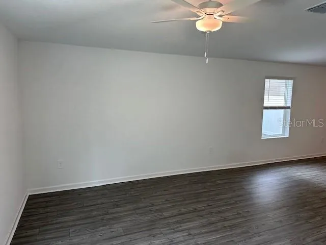 a view of a room with wooden floor and chandelier