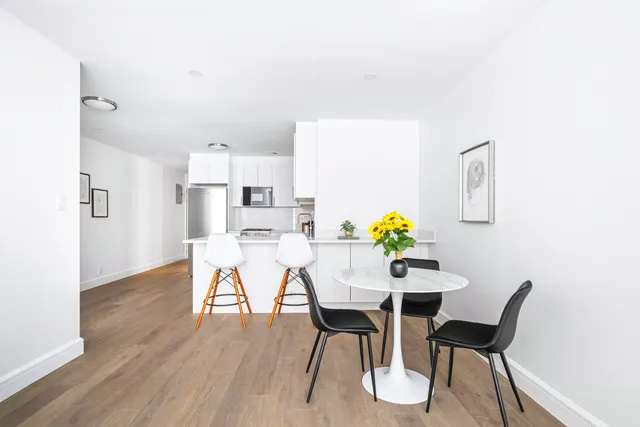 a kitchen with cabinets stainless steel appliances a sink and wooden floor