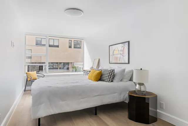 a view of a kitchen sink and wooden floor