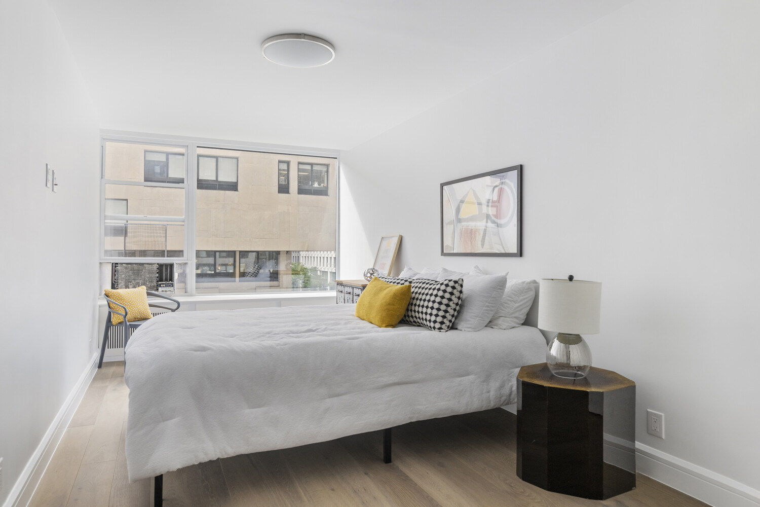 315 7th Avenue, Unit 3C Manhattan, NY 10001 - Photo 5 of 9 a bedroom with a bed and a table