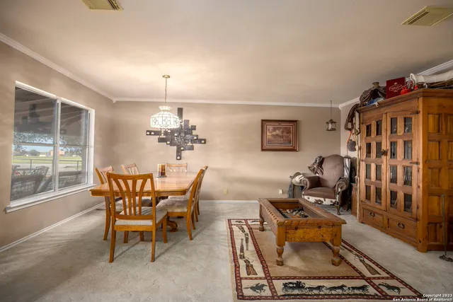a dining room with furniture a rug and a chandelier