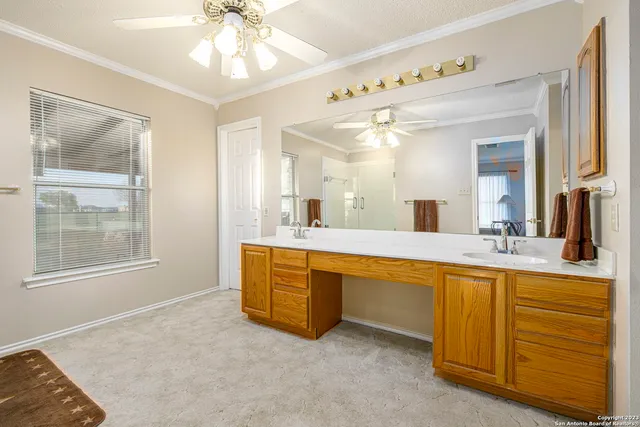 a spacious bathroom with a granite countertop sink mirror and a bathtub