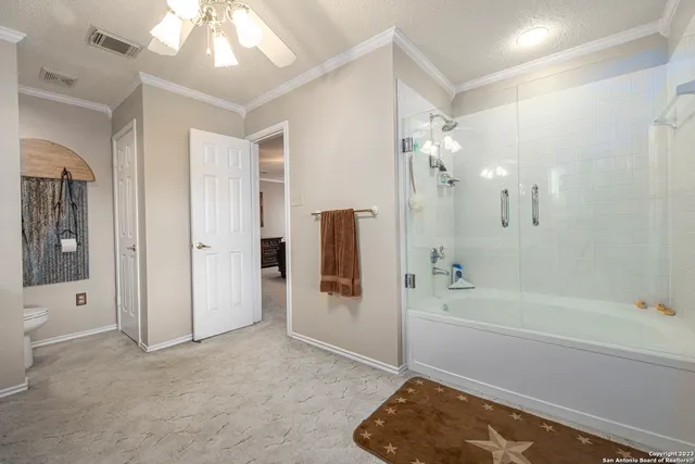 a bathroom with a tub shower and sink
