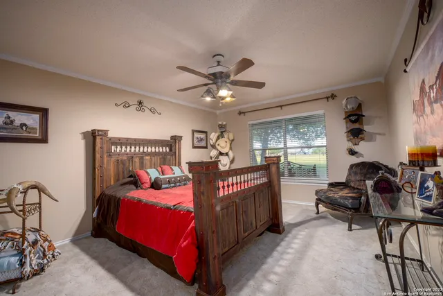 a bedroom with furniture and a large window