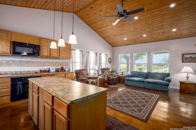 a kitchen with a stove a sink and a microwave