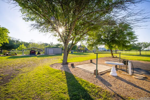 a view of a swimming pool with a table and chairs