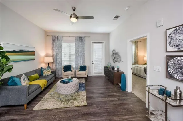 a living room with furniture and wooden floor