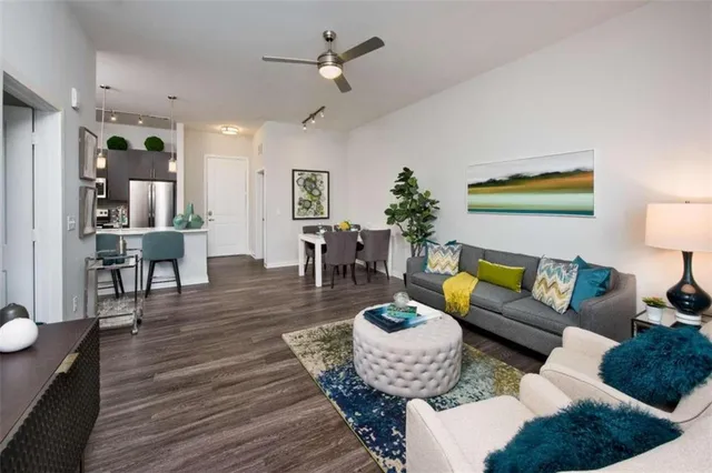 a living room with furniture and wooden floor