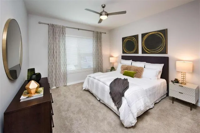 a bedroom with a bed dresser and a window