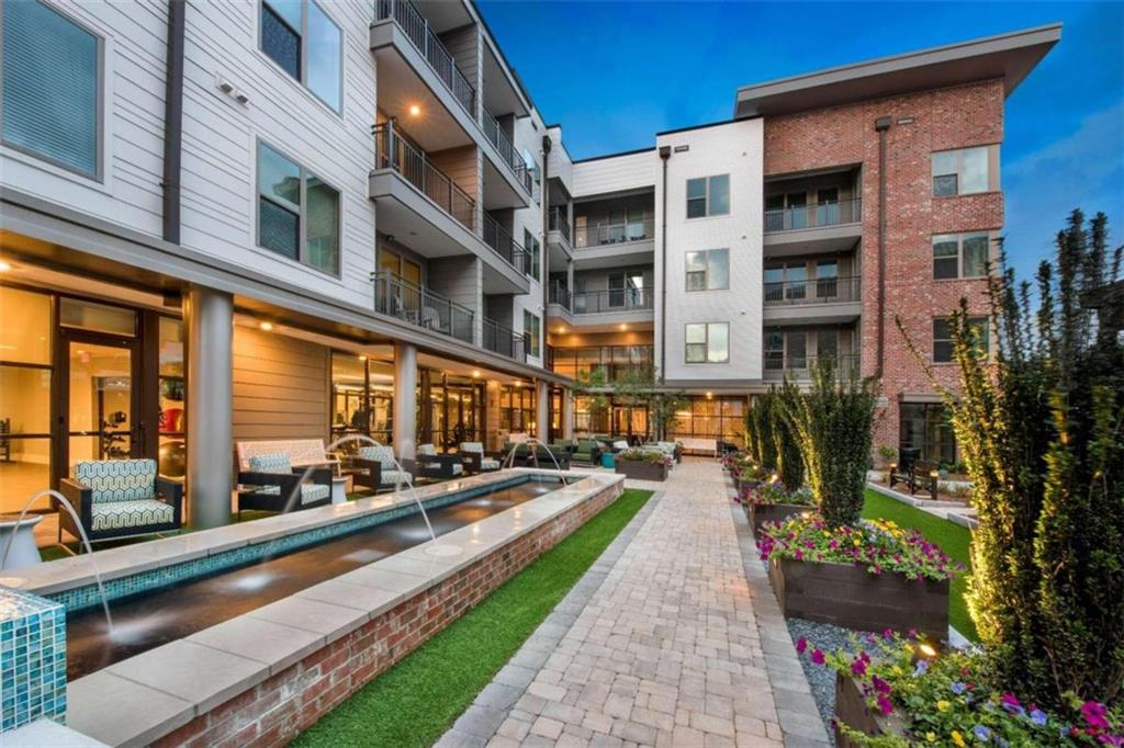 1490 Ernest W Barrett Parkway Northwest, Unit 314 Kennesaw, GA 30152 - Photo 24 of 30 a city street lined with tall buildings and a yard