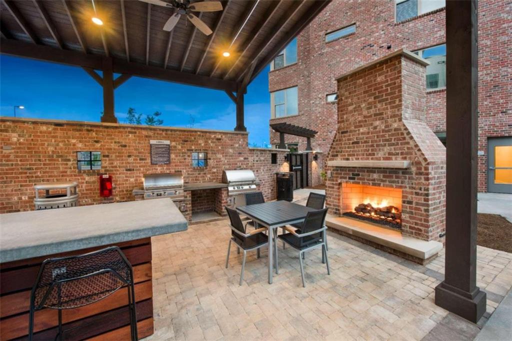 1490 Ernest W Barrett Parkway Northwest, Unit 314 Kennesaw, GA 30152 - Photo 26 of 30 a outdoor dining space with furniture and a fireplace
