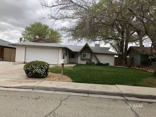 305 West Perdew Avenue Ridgecrest, CA 93555 - Photo 1 of 9 a front view of a house with a garden