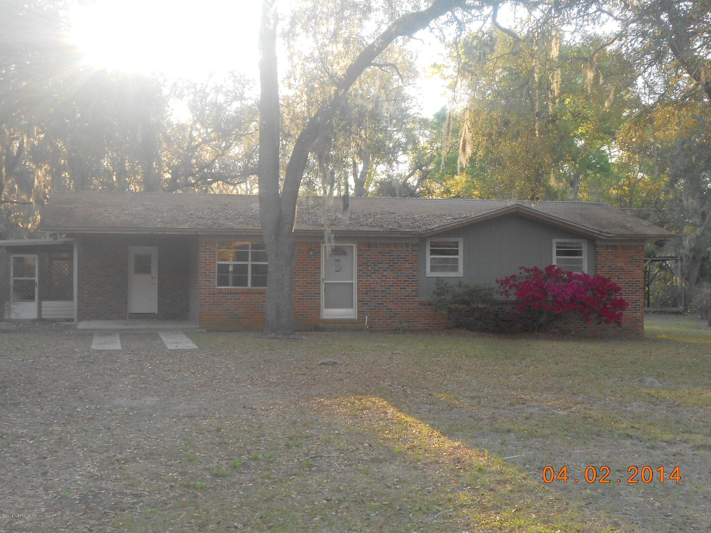 96770 Chester Road Yulee, FL 32097 - Photo 1 of 12 front view of a house with a yard