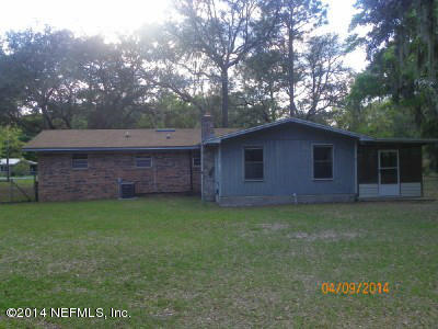 96770 Chester Road Yulee, FL 32097 - Photo 2 of 12 a backyard of a house with lots of green space
