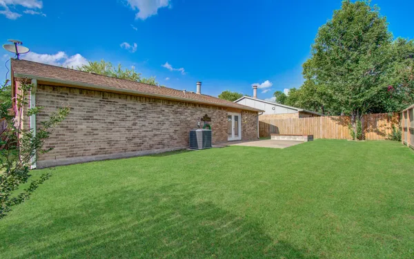a front view of house with a garden