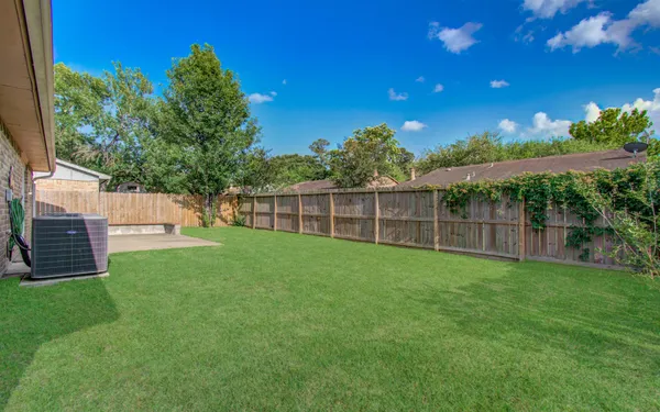 a view of a backyard with a garden and deck