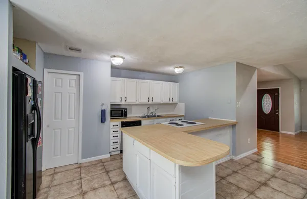 a kitchen that has a sink a refrigerator and a stove