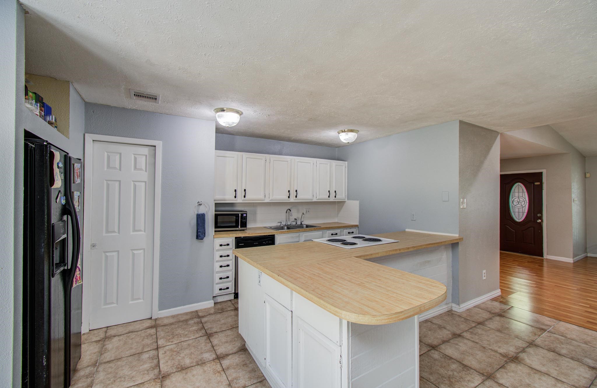 5706 Spring Grove Lane Spring, TX 77373 - Photo 4 of 12 a kitchen that has a sink a refrigerator and a stove