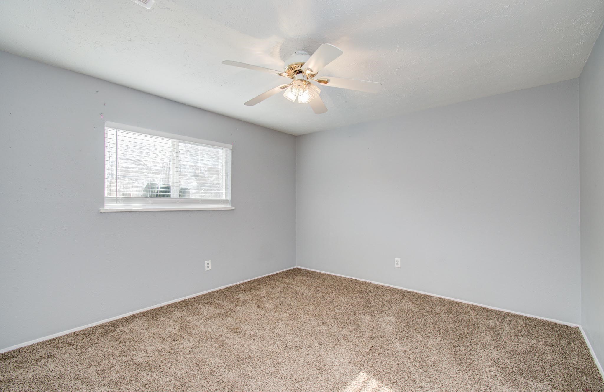 5706 Spring Grove Lane Spring, TX 77373 - Photo 8 of 12 an empty room with a window and a ceiling fan
