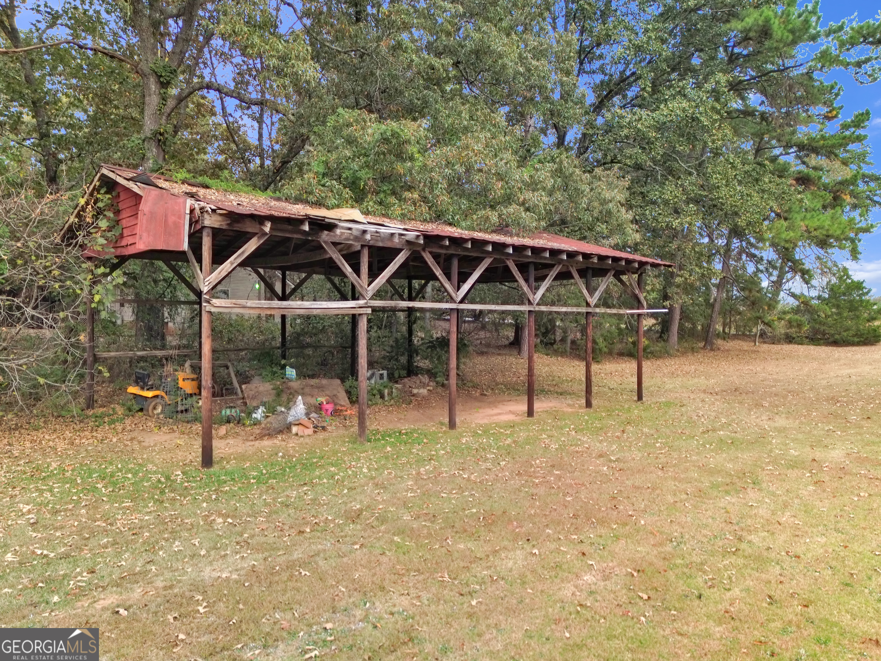 66 Ellis Trail Covington, GA 30016 - Photo 11 of 39 a view of a chairs and table in the backyard